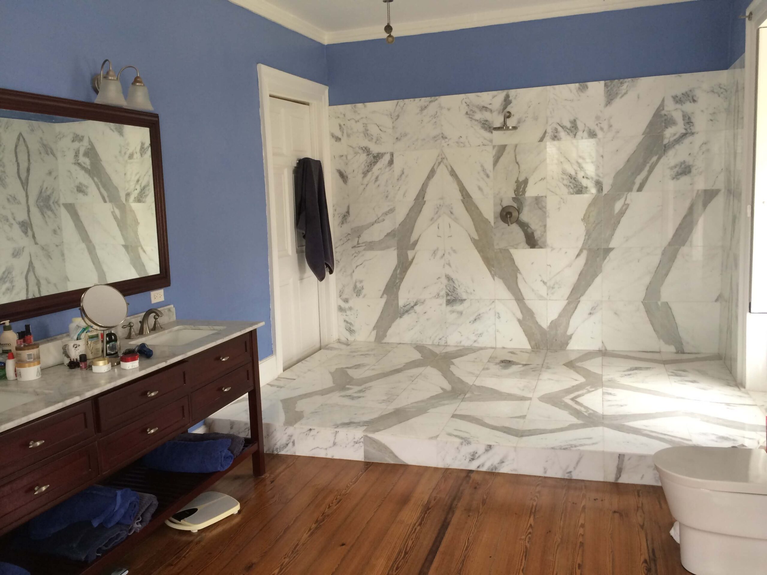 master bathroom with walk in open marble shower