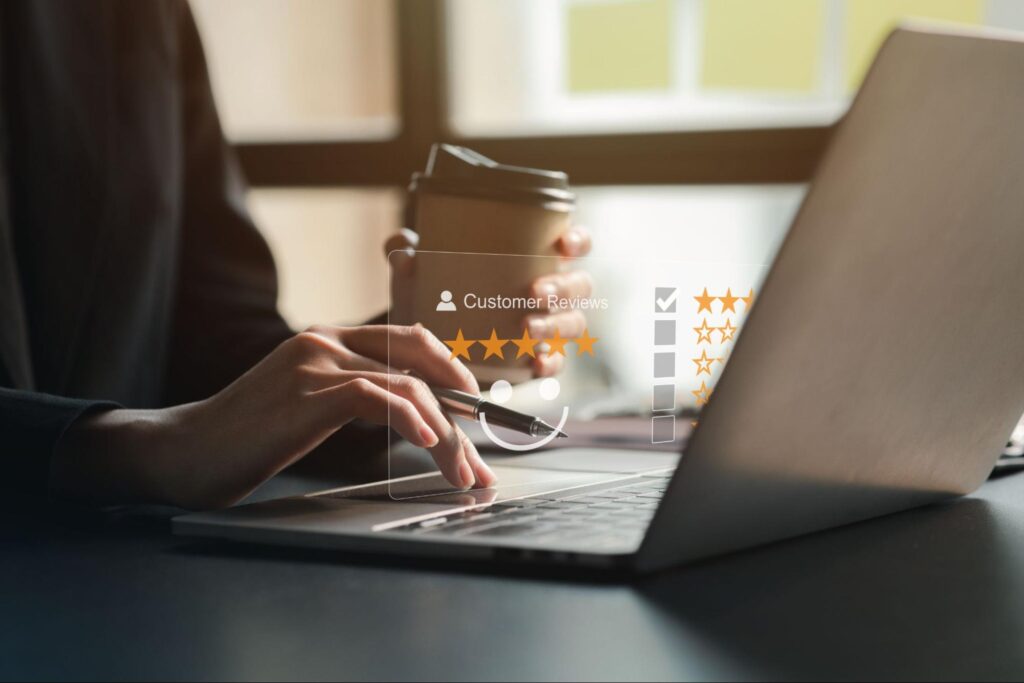 A person reading online reviews for real estate agents, highlighting the importance of client testimonials for building trust.