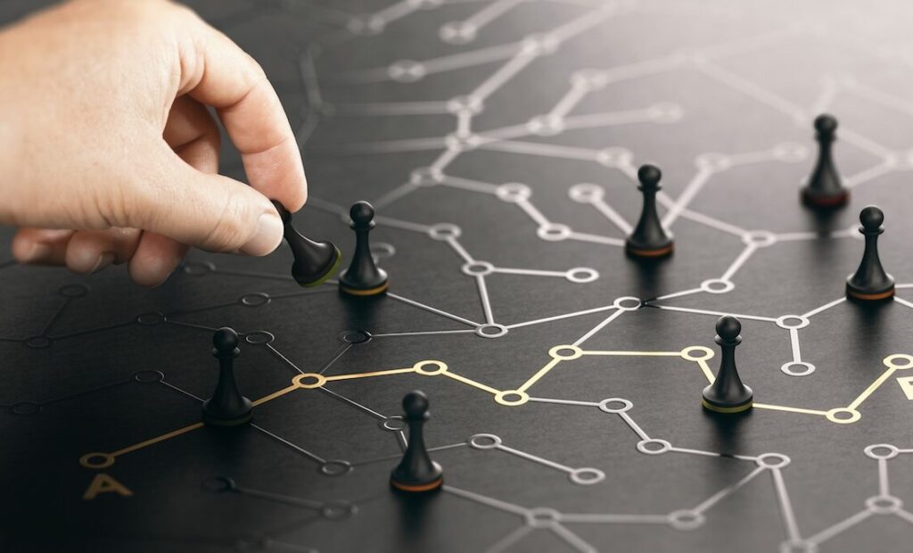 Hand moving pawn on a conceptual labyrinth. Shortcut from point A to B or career guidance concept. Composite image between a hand photography and a 3D background.